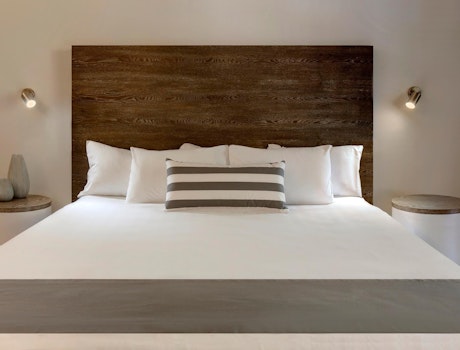 Bed in a Palm Bungalows Resort room Hamilton Island