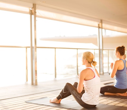 Relax with yoga on the Bommie deck - Hamilton Island luxury resorts  
