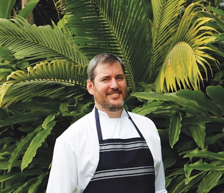Adam Woodfield, chef at Whitsunday Island resort restaurant, coca chu – a popular choice among people enjoying Queensland family holiday packages.