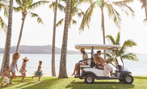 Family in buggy on Hamilton Island in the heart of Australia's Great Barrier Reef.